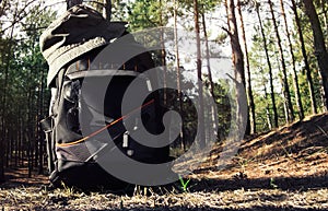 Backpack with panama hat in forest.