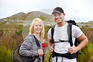 Backpack, portrait of woman and man with smile on hiking adventure in mountain with nature walk, freedom or wellness