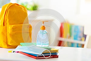 Backpack of school child. Face mask and sanitizer photo