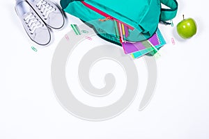 Backpack with school stationery on white background