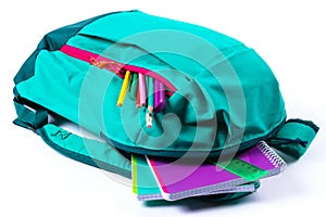 Backpack with school stationery on white background