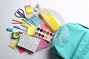 Backpack and school stationery on white background, flat lay. Back to school
