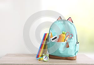Backpack with school supplies,back to school empty space backdrop