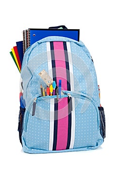 Backpack with school supplies on white