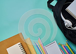 Backpack with stationery on blue background