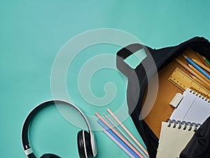 Backpack with stationery on blue background