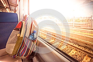 Backpack on the train near the window. Travel conceptual image.