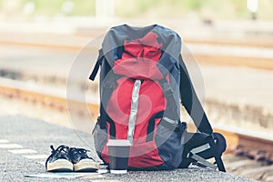 Backpack traveler for adventure trips at the train station near railway.