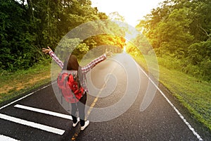 Backpack woman open hand on road