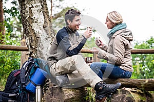 Backpacker couple taking rest aside hiking trail