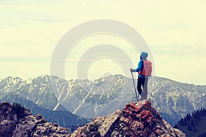 backpacker enjoy the view on mountain peak cliff