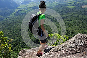 Backpacker enjoy the view on mountain top cliff