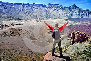 Man at the top of the Mirador de la Ruleta in Teide park on the island of Tenerife photo