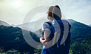 backpacker enjoying the view on morning mountain