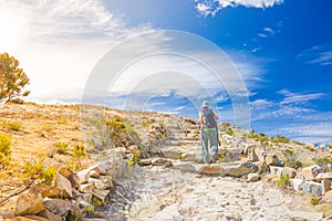 Backpacker explores Inca Trail on Island of the Sun, Titicaca Lake, scenic travel destination in Bolivia. Travel adventures and va