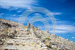 Backpacker exploring the majestic Inca Trails on Island of the Sun, Titicaca Lake, among the most scenic travel destination in Bol