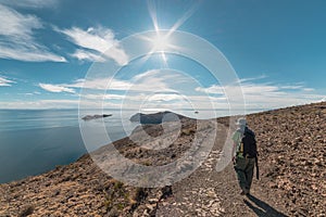 Backpacker exploring the majestic Inca Trails on Island of the Sun, Titicaca Lake, among the most scenic travel destination in Bol