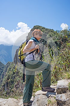 Backpacker exploring the steep Inca Trail of Machu Picchu, the most visited travel destination in Peru. Summer adventures in South