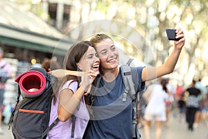 Backpacker friends taking selfie with a phone