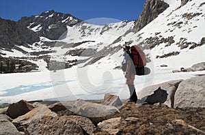 Backpacker by frozen lake