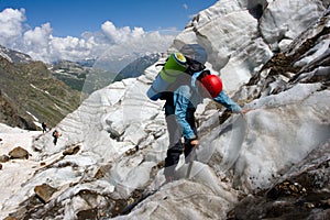 Backpacker girl with ice-axe