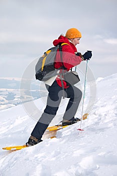 Backpacker girl in snow shoes