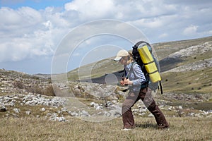 Backpacker girl traveling in mountains