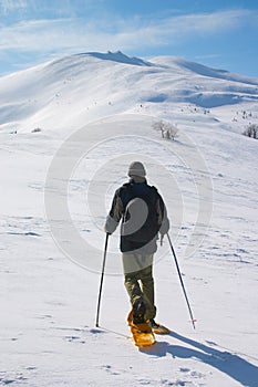 Backpacker going to snow mountain