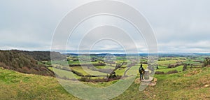 backpacker hiker on the high ground of Coaley Peak, Stroud, Gloucestershire, UK photo