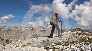 Backpacker hiking in montain landscape. Summer adventures on Dolomites Alps
