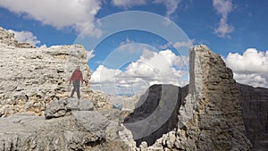 Backpacker hiking in montain landscape. Summer adventures on Dolomites Alps