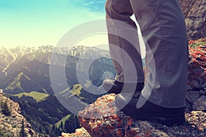 Backpacker hiking on mountain peak cliff