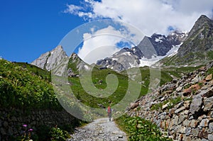 Backpacker hiking in the mountains on a tourist tr