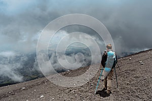 Backpacker hiking to Etna,Sicily,Italy.Adventure outdoor activity.Excursion on summit of volcano.Parco dell`Etna,protected nature photo