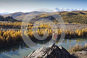 Backpacker Looking at the River Valley in Altai Mountains