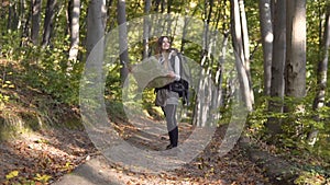 Backpacker looks at map in wood