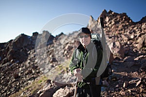 Backpacker in morning mountains