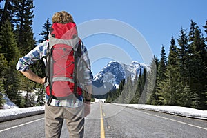 Backpacker on mountain road photo