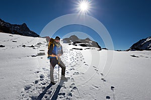 Backpacker mountaineer man standing rest snow mountain.