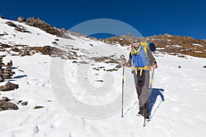 Backpacker mountaineer man standing rest snow mountain.