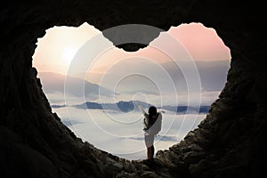 Backpacker outstretched hands in cave