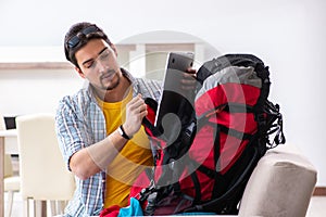 The backpacker packing for his trip