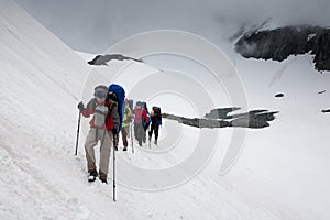 Backpacker passes snow field