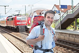 Backpacker at railway station with train