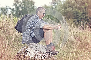 Backpacker sitting on a rock