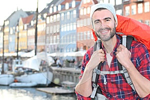 Backpacker smiling in the epic Nyhavn, Copenhagen, Denmark