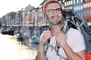 Backpacker smiling in the epic Nyhavn, Copenhagen, Denmark