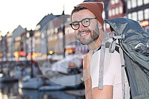 Backpacker smiling in the epic Nyhavn, Copenhagen, Denmark