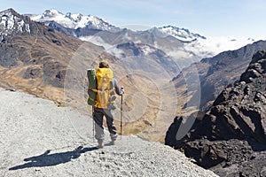 Backpacker standing hiking tourist mountain edge trail, Bolivia