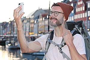 Backpacker taking a selfie in Nyhavn, Copenhagen, Denmark